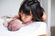 © Sam Edwards/Caia Image - Mother kissing newborn baby son