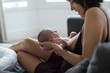 © Sam Edwards/Caia Image - Mother holding and breastfeeding newborn baby son