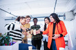 © Sam Edwards/Caia Image - Businesswomen celebrating new office, pouring champagne