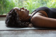 © Tom Merton/Caia Image - Serene young woman laying in corpse pose on yoga mat