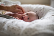 © Sam Edwards/Caia Image - Cute newborn baby boy laying in bassinet
