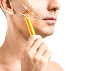 Poster - Young man massaging his face against white background, closeup