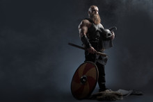 Medieval Warrior Berserk Viking With Tattoo With Axes Attacks Enemy. Concept Historical Photo