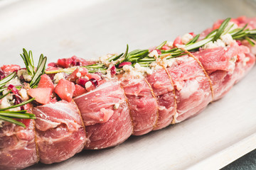 Wall Mural - Raw pork loin with fruits, blue cheese and rosemary ready for baking. Selective focus. Shallow depth of field.