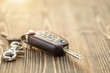 © SKT Studio - New car keys with black leather cover on wooden table