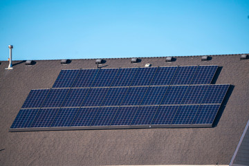 Poster - Array of solar panels on a house roof in close up