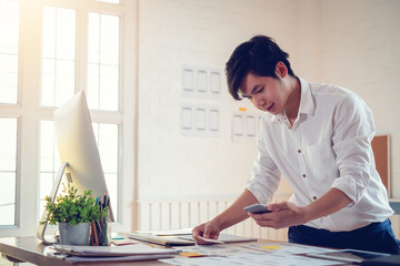 Wall Mural - designer man with computer and laptop planning application for mobile phone. ux ui designer concept.