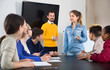 © JackF - Female student answering teacher’s question at writing board