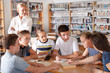 © JackF - Teenage group of pupils sitting at table and studying