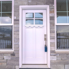 Wall Mural - Square frame White entrance door to a house flanked by windows