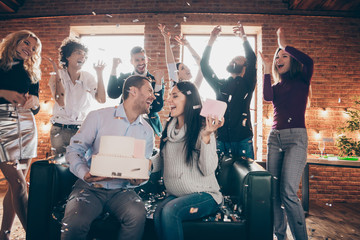 Wall Mural - Photo of group amazing friends meeting surprise baby party wedding anniversary future parents sit sofa hold big cake kissing confetti fall formalwear restaurant indoors