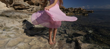 Woman In Pink Dress On The Beach