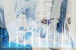© peshkova - Double exposure of chart with businessman typing on computer in office on background. Concept of hard work.