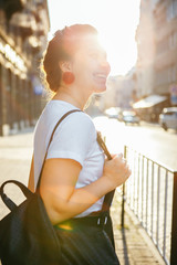 Wall Mural - portrait of pretty woman on sunset at city street