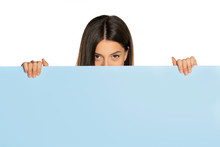 Young Beautiful Woman Peeking Behind A Blue Empty Board