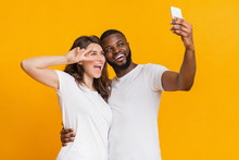 Cheerful Interracial Couple Taking Selfie With Smartphone, Having Fun Together