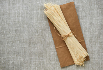 Wall Mural - Raw spaghetti on a gray fabric background