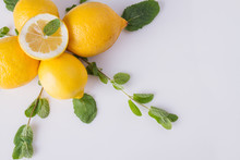 Composition With Lemon And Mint Leaves. Lemons And Green Mint On White Background. Space For Text.