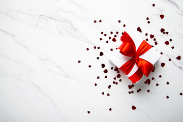 Wall Mural - white gifts with red ribbon, present on white marble background top view. happy holidays. valentine'