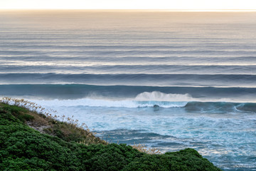 Wall Mural - View of Auckland West Coast with perfect long regular parallel surfing waves in background