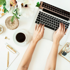 Wall Mural - Woman hands working on laptop. Home office desk table workspace with laptop on white background. Flat lay, top view freelance work concept.