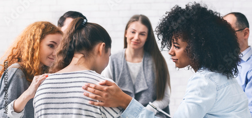 Fotografía Support group patients comforting woman at therapy session