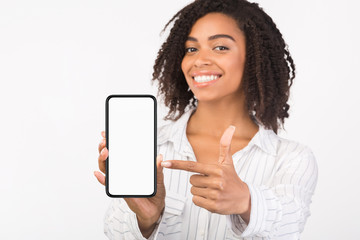 Happy black girl showing white mobile screen