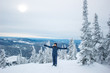 © Марина Демешко - Beautiful girl with the braids in grey winter costume stands with her arms outstretched and smiles on top of the mountain. Amazing winter landscape