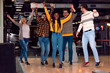 © Zoran Zeremski - Group of friends enjoying time together laughing and cheering while bowling at club.