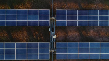 technician and investor using infrared drone technology to inspect solar panels and wind turbines in