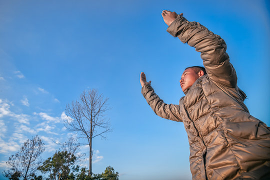 Man lift hands praying at mountain. christian concept.