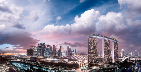 Singapore at sunset. Aerial view of Marina Bay and Downtown from drone