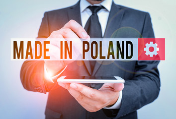 Text sign showing Made In Poland. Business photo text A product or something that is analysisufactured in Poland Male human wear formal work suit hold smart hi tech smartphone use one hand