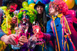 © karepa - Happy girls and boys at Carnival Party clinking glasses with champagne.