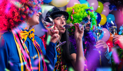 Wall Mural - Happy girls and boys at Carnival Party clinking glasses with champagne.