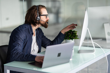 Customer service representative man wearing a headset at the office