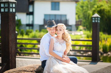 Wall Mural - Loving couple in the summer on the nature. Newlyweds on a summer walk in the park. Wedding Ukrainian couple in Dnieper.