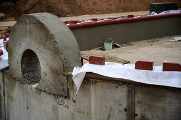 Concrete wall construction on the street. Work and improvement of the park in the city. Creating a foundation of cement and sand.