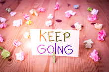 Conceptual Hand Writing Showing Keep Going. Concept Meaning Make An Effort To Live Normally When In A Difficult Situation Colored Crumpled Papers Wooden Floor Background Clothespin