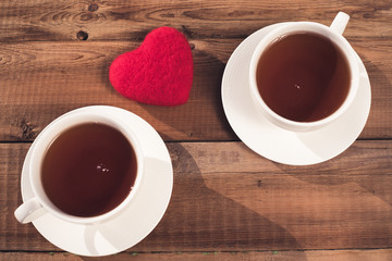 two cups of tea, heart, top view on a rustic background. Valentine's Day