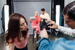 © LIGHTFIELD STUDIOS - selective focus of art director pointing with hand at display of digital camera near assistants