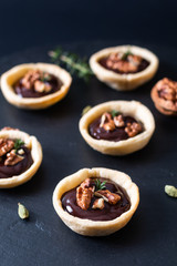 Wall Mural - Food concept Homemade rustic organic mini chocolate and walnuts tarts on black slate stone plate with copy space