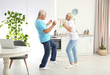 © New Africa - Happy mature couple dancing together in kitchen