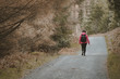 © Alvaro Sanchez/ADDICTIVE STOCK - Back view of anonymous woman traveler in warm jacket walking on forest while visiting Tollymore Forest Park in Northern Ireland in spring day