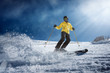 © Alvaro Sanchez/ADDICTIVE STOCK - Full body young man in yellow outwear and sunglasses riding skis on snowy mountain slope on sunny winter day on resort