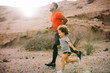 © Gabriel Trujillo/ADDICTIVE STOCK - African American bearded active father in red t shirt running with cheerful curly child on desert landscape in backlit