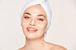 © Indico Studio/ADDICTIVE STOCK - Delighted female with radiant skin applying cream
