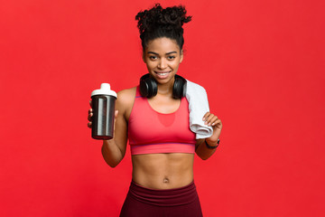 Wall Mural - Happy fitness afro girl recommending high quality protein