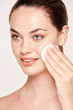 © Indico Studio/ADDICTIVE STOCK - Peaceful female applying toner on radiant face with sponge