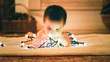 © Stockhunters/ADDICTIVE STOCK - Baby playing with light garland on Christmas Day
